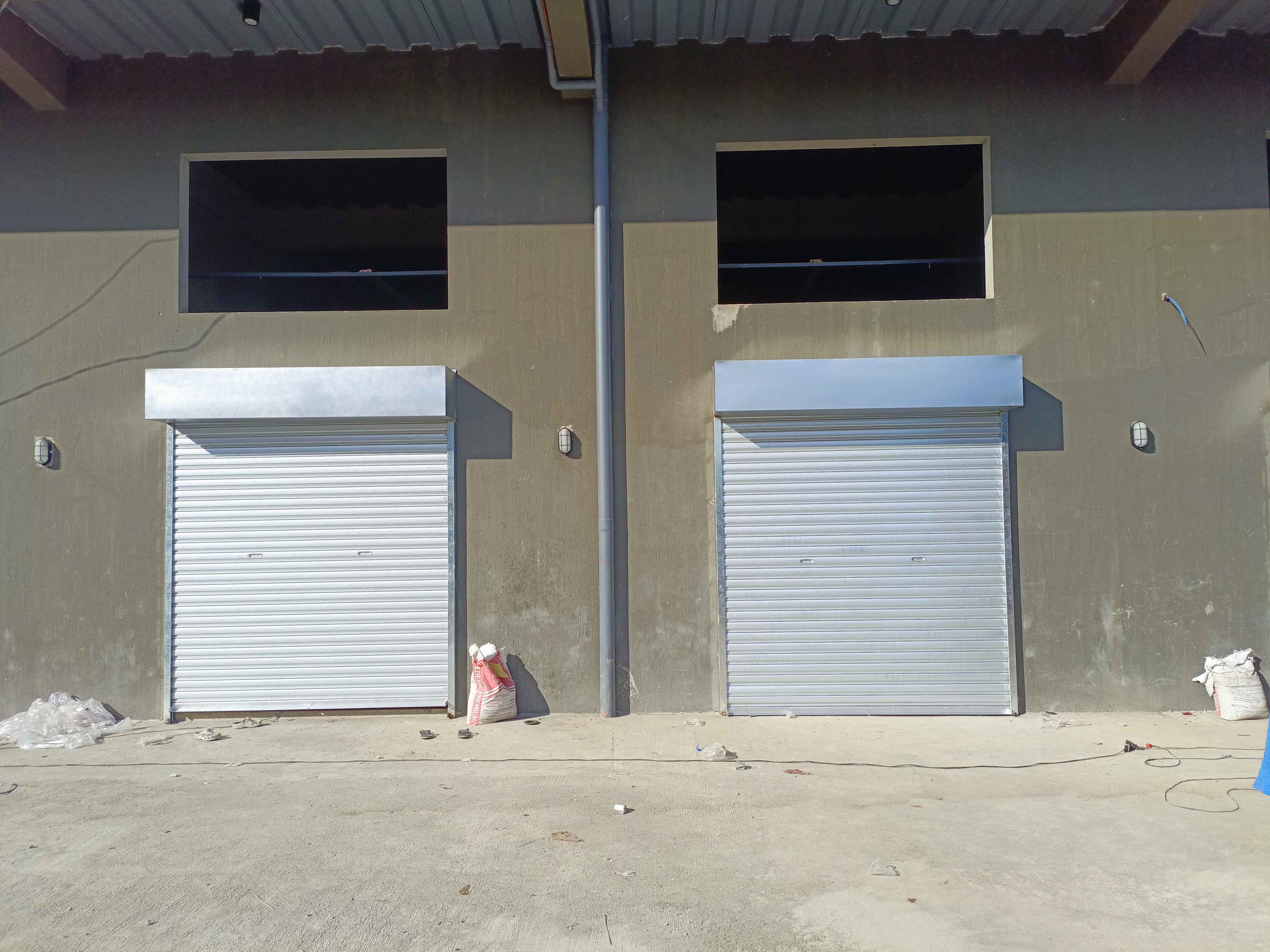 Two exterior rollup doors installed side by side