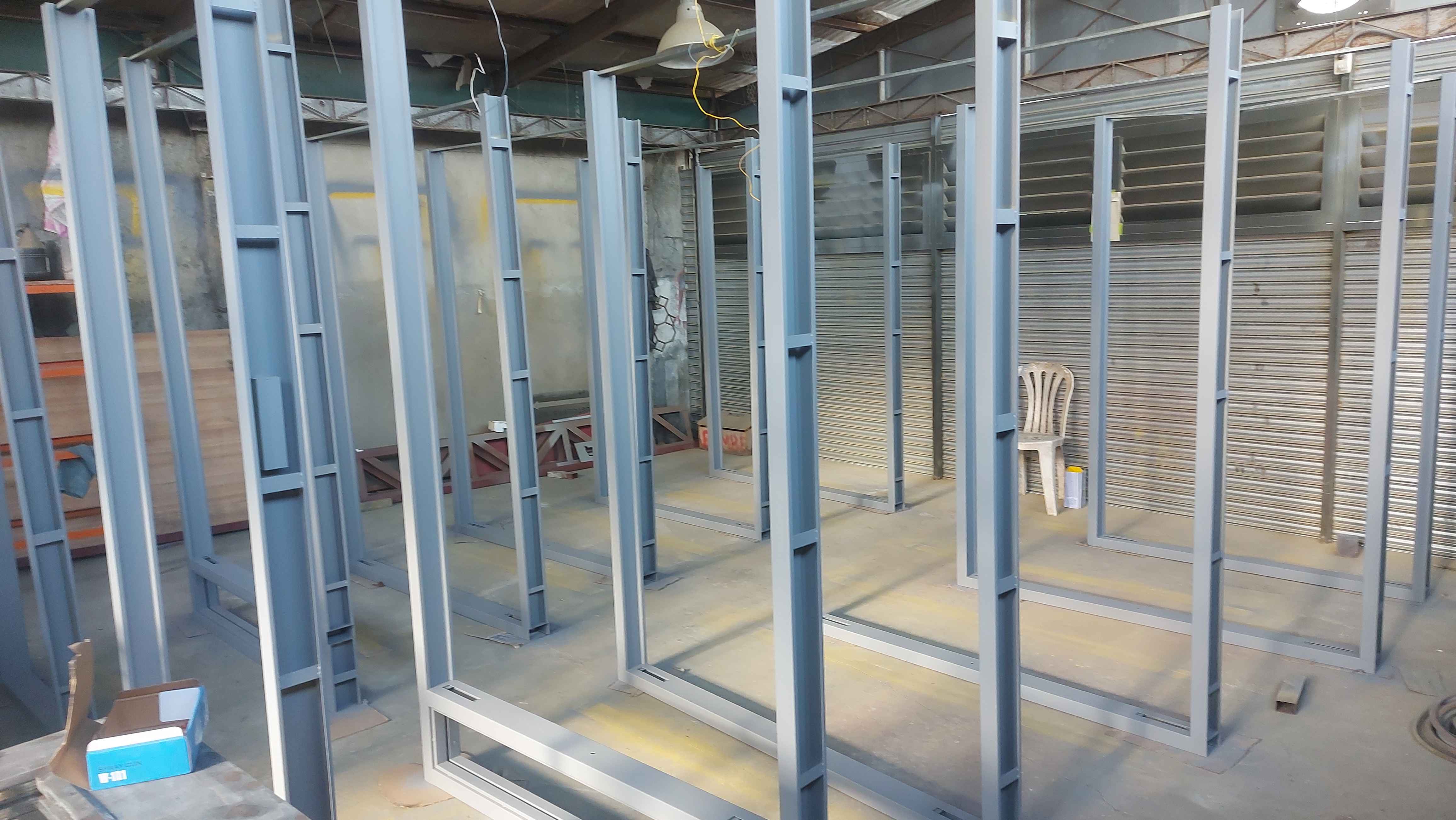 Freshly fabricated steel door units lined up in the workshop